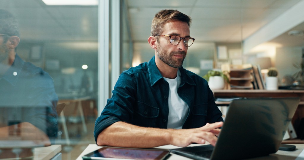 Office worker reviewing information on a laptop before sharing it with an AI tool