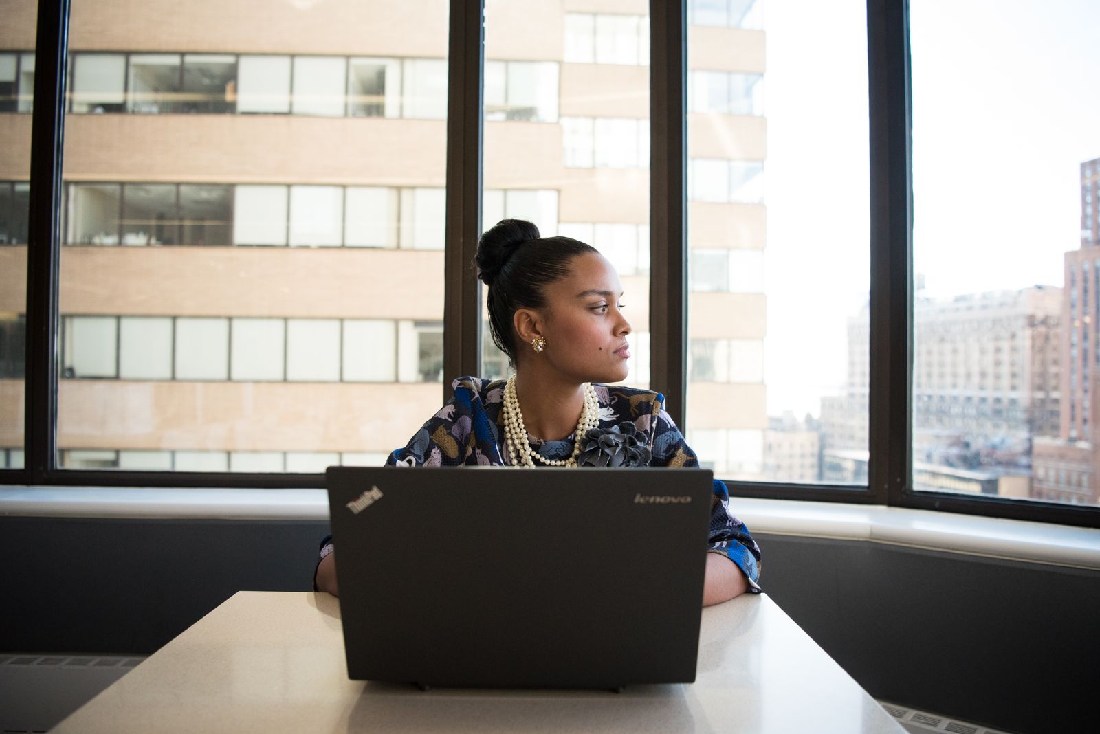 Woman sitting at a black laptop choosing a good master password for her vault